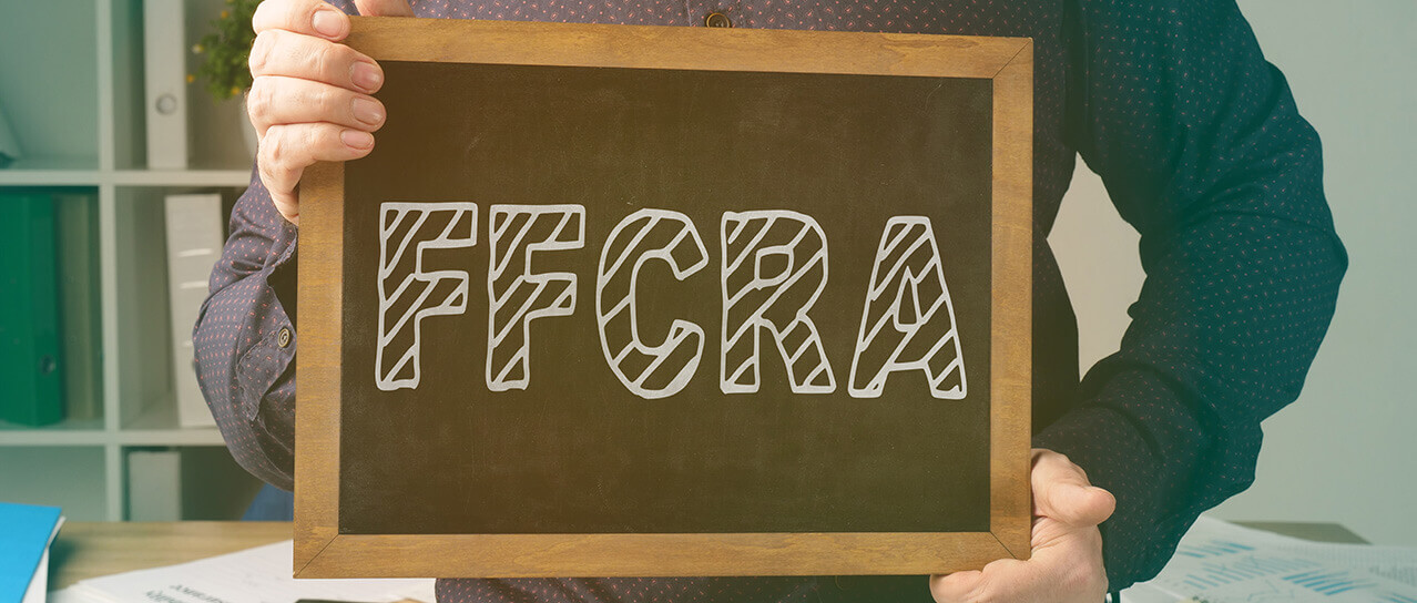 Man holding sign that says FFCRA
